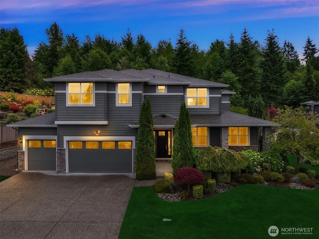 19501 58th Ave SE, Bothell, WA 98012 - view of front of property featuring concrete driveway, a garage, a yard, stone siding, and a shingled roof