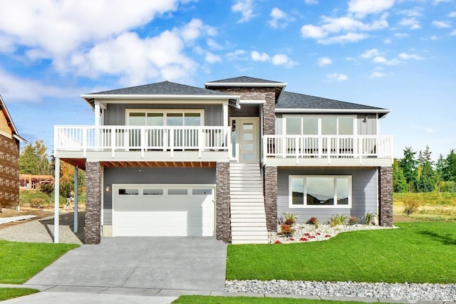 5412 Lonicera Dr, Blaine, WA 98230 - view of front of house featuring stone siding, concrete driveway, an attached garage, and a front lawn