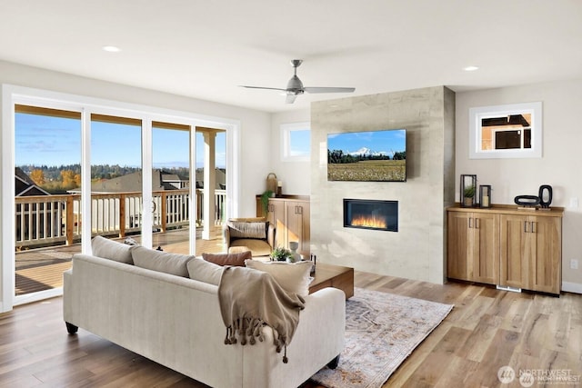 5412 Lonicera Dr, Blaine, WA 98230 - living area featuring a tiled fireplace, light wood-type flooring, ceiling fan, and recessed lighting