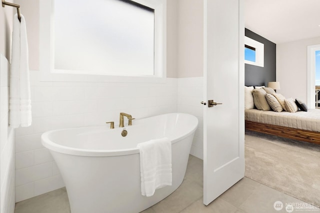 5412 Lonicera Dr, Blaine, WA 98230 - bathroom featuring tile walls, plenty of natural light, a freestanding bath, connected bathroom, and tile patterned floors