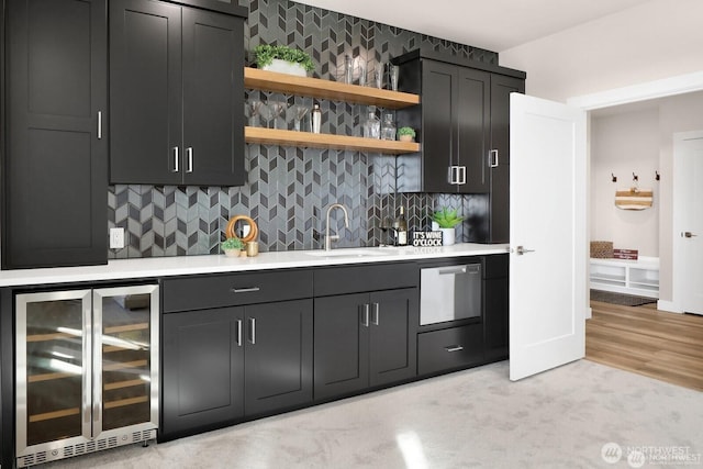 5412 Lonicera Dr, Blaine, WA 98230 - indoor bar featuring beverage cooler, stainless steel dishwasher, backsplash, and light colored carpet