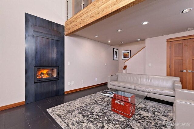 11261 E State Route 106, Union, WA 98592 - living room featuring a fireplace, recessed lighting, dark tile patterned flooring, and stairs
