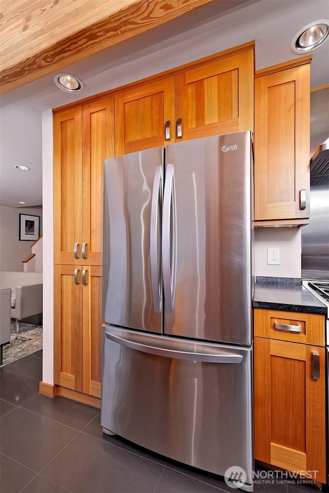 11261 E State Route 106, Union, WA 98592 - kitchen featuring freestanding refrigerator, dark countertops, brown cabinetry, dark tile patterned flooring, and recessed lighting