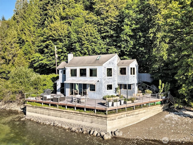 11261 E State Route 106, Union, WA 98592 - back of house featuring a chimney, a deck with water view, and a forest view