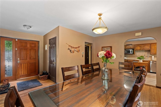 1714 N Astor Ct, East Wenatchee, WA 98802 - dining space with arched walkways and light wood-type flooring