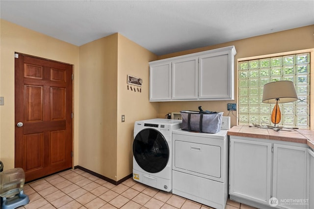 1714 N Astor Ct, East Wenatchee, WA 98802 - laundry area featuring cabinet space, separate washer and dryer, and light tile patterned floors