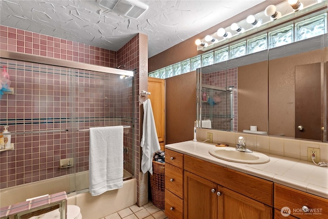 1714 N Astor Ct, East Wenatchee, WA 98802 - bathroom featuring vanity, bath / shower combo with glass door, and tile patterned flooring