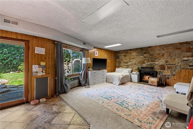 1714 N Astor Ct, East Wenatchee, WA 98802 - living room featuring wood walls, a textured ceiling, and a fireplace