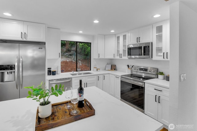 11214 80th Ave NE, Kirkland, WA 98034 - kitchen featuring stainless steel appliances, recessed lighting, glass insert cabinets, white cabinetry, and light stone countertops