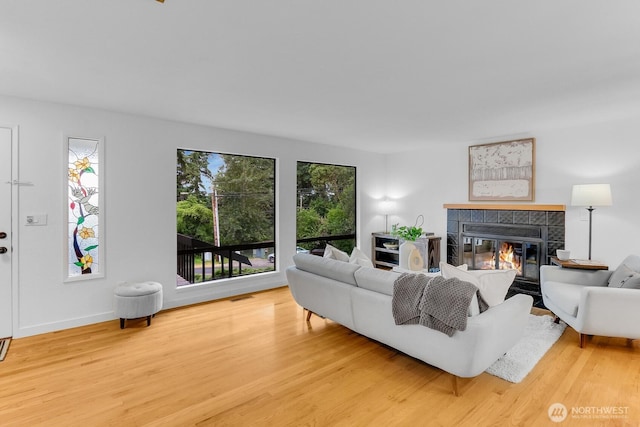 11214 80th Ave NE, Kirkland, WA 98034 - living area featuring a tiled fireplace and wood finished floors