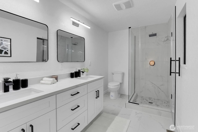 11214 80th Ave NE, Kirkland, WA 98034 - bathroom featuring marble look tile flooring, a marble finish shower, double vanity, and a textured ceiling