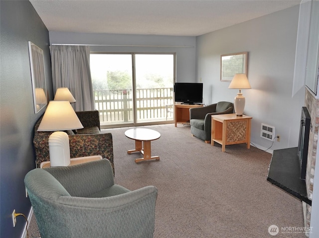 615 Ocean Shores Blvd NW Unit 210, Ocean Shores, WA 98569 - living room with carpet flooring and a fireplace with raised hearth