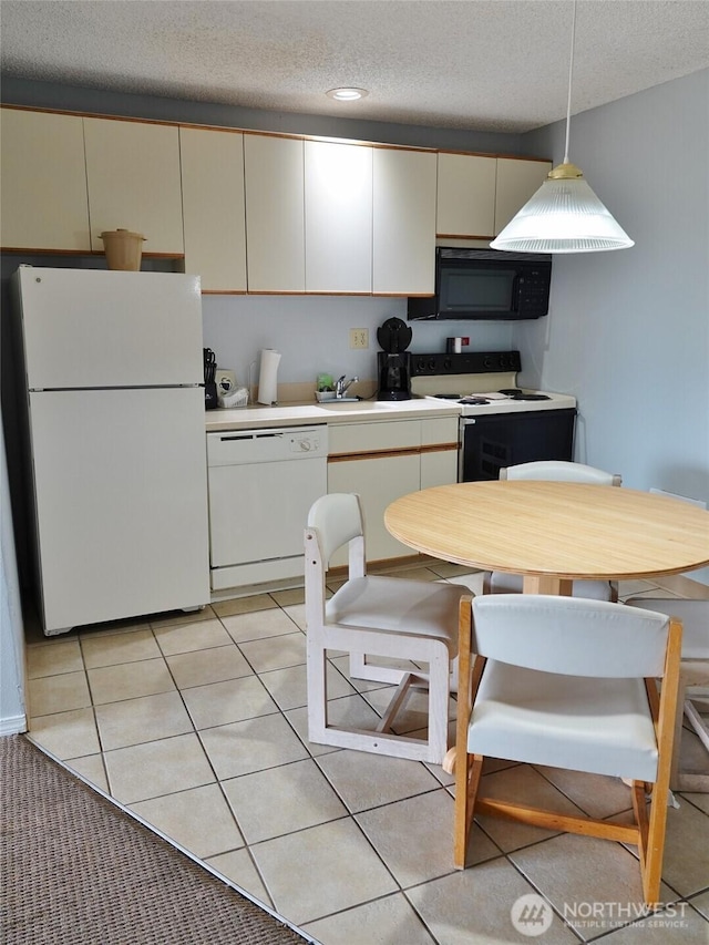 615 Ocean Shores Blvd NW Unit 210, Ocean Shores, WA 98569 - kitchen with white appliances, a textured ceiling, light countertops, decorative light fixtures, and light tile patterned floors