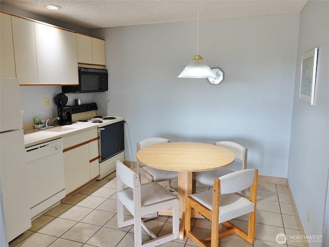 615 Ocean Shores Blvd NW Unit 210, Ocean Shores, WA 98569 - kitchen with white appliances, light countertops, light tile patterned flooring, hanging light fixtures, and a textured ceiling