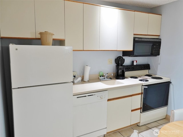 615 Ocean Shores Blvd NW Unit 210, Ocean Shores, WA 98569 - kitchen featuring white appliances, light countertops, and light tile patterned floors