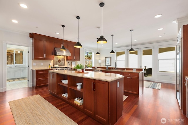 603 9th Ave, Kirkland, WA 98033 - kitchen with ventilation hood, a center island with sink, open shelves, tasteful backsplash, and dark wood-style floors