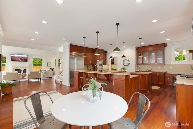 603 9th Ave, Kirkland, WA 98033 - dining space with dark wood-style flooring, recessed lighting, a fireplace, and ornamental molding