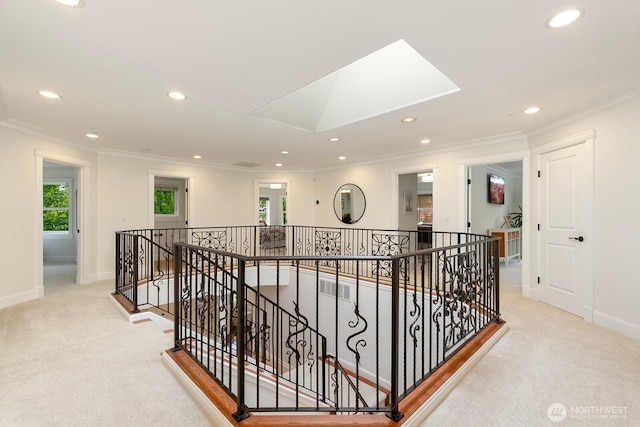 603 9th Ave, Kirkland, WA 98033 - hall with an upstairs landing, carpet floors, crown molding, recessed lighting, and a skylight