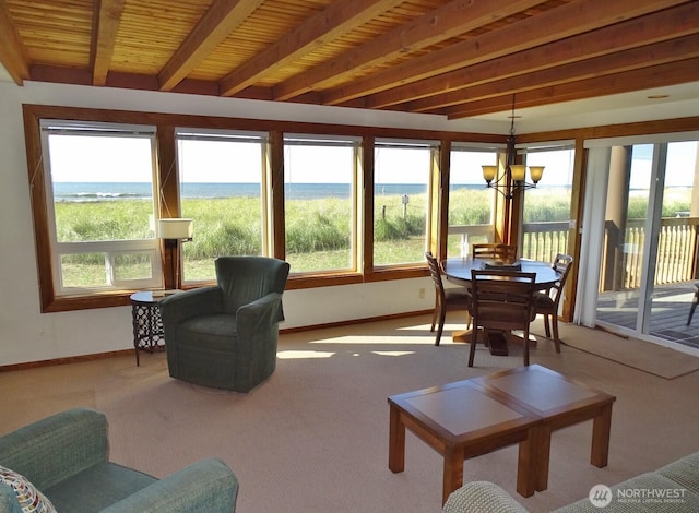 1407 Ocean Shores Blvd SW Unit 1N-I, Ocean Shores, WA 98569 - sunroom featuring beamed ceiling, carpet flooring, a chandelier, and a water view