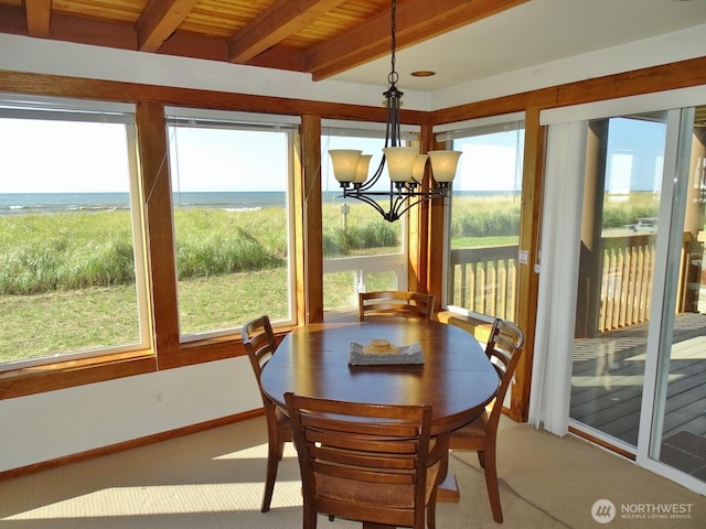 1407 Ocean Shores Blvd SW Unit 1N-I, Ocean Shores, WA 98569 - sunroom / solarium with carpet floors, a chandelier, and a wood ceiling with exposed beams