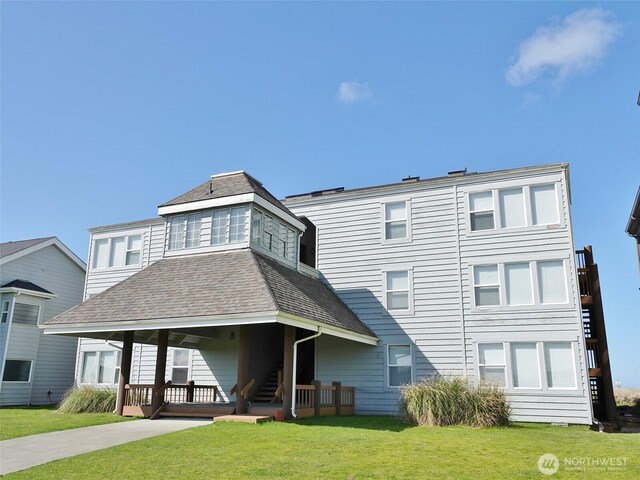 1407 Ocean Shores Blvd SW Unit 1N-I, Ocean Shores, WA 98569 - rear view of house with a lawn and a shingled roof