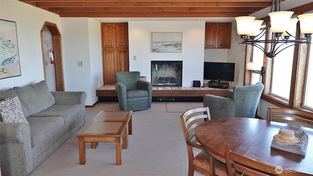 1407 Ocean Shores Blvd SW Unit 1N-I, Ocean Shores, WA 98569 - living room featuring a chandelier, light carpet, and a glass covered fireplace