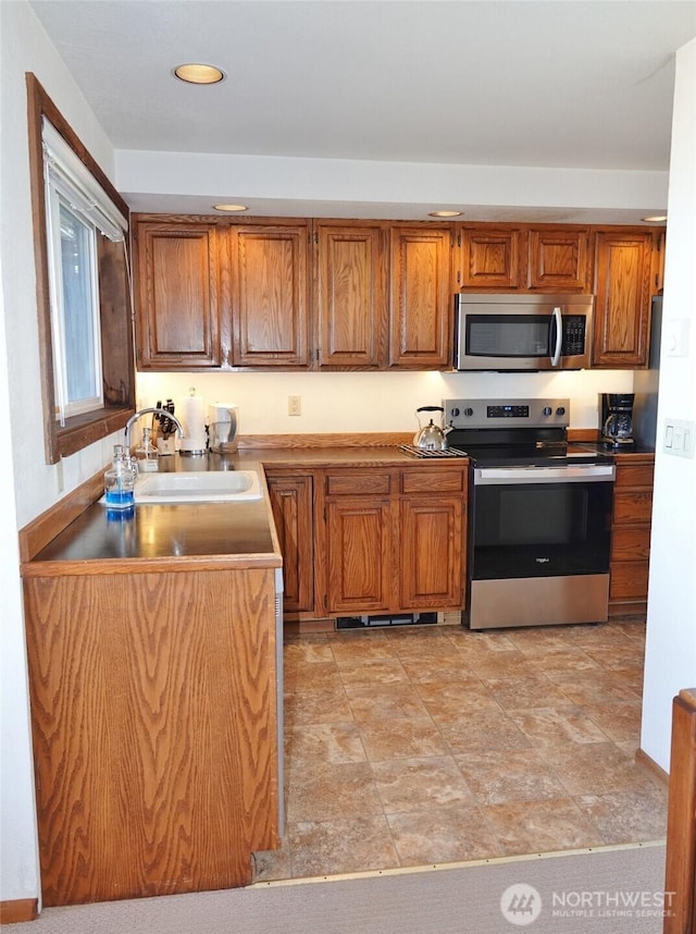1407 Ocean Shores Blvd SW Unit 1N-I, Ocean Shores, WA 98569 - kitchen with appliances with stainless steel finishes, brown cabinets, and recessed lighting