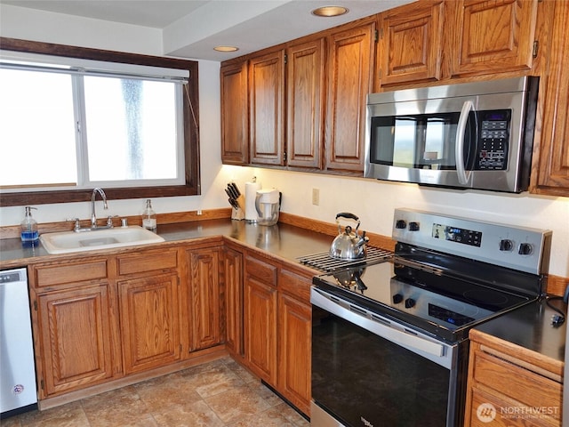 1407 Ocean Shores Blvd SW Unit 1N-I, Ocean Shores, WA 98569 - kitchen with stainless steel appliances, brown cabinets, and recessed lighting