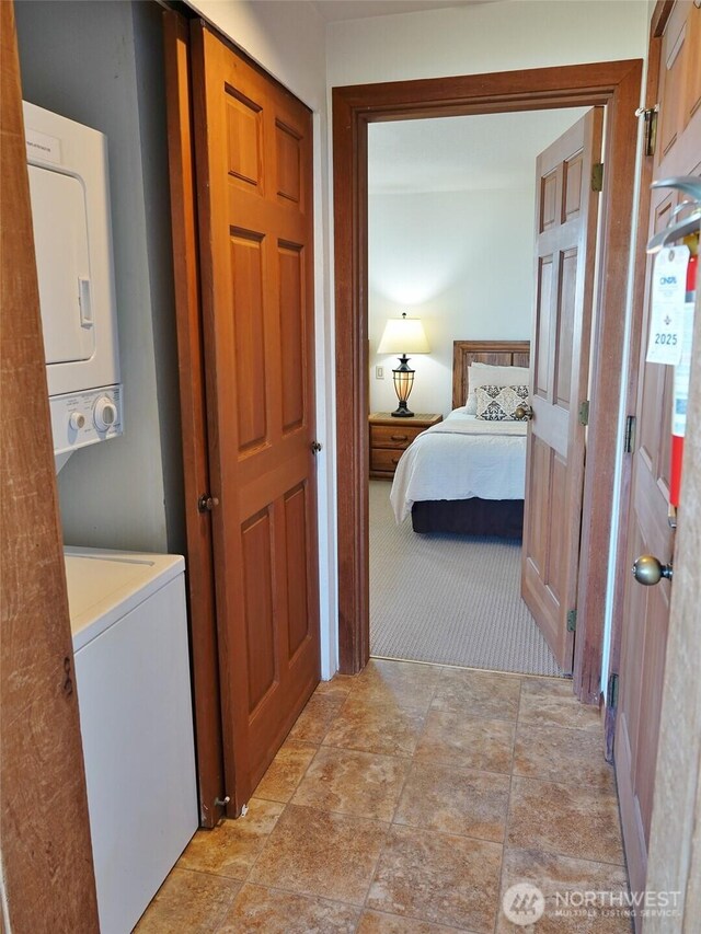 1407 Ocean Shores Blvd SW Unit 1N-I, Ocean Shores, WA 98569 - washroom with stacked washer / dryer and light carpet