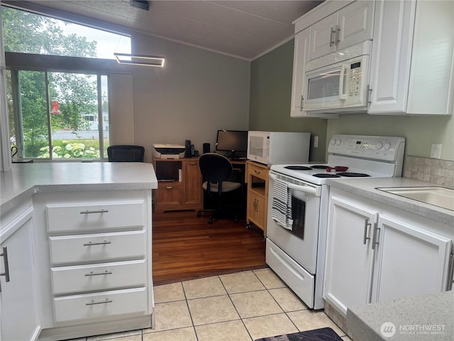 3611 I St NE Unit 291, Auburn, WA 98002 - kitchen with white appliances, ornamental molding, light countertops, white cabinetry, and light tile patterned floors