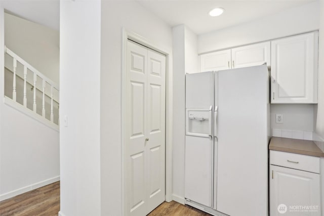 21616 9th Ave SE Unit C-105, Bothell, WA 98021 - kitchen with white refrigerator with ice dispenser, white cabinetry, light wood-type flooring, and recessed lighting
