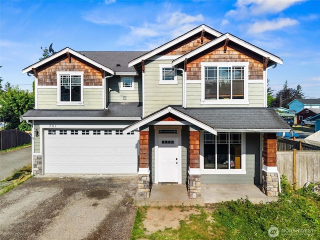 701 Stratford Pl, Sultan, WA 98294 - craftsman-style house featuring an attached garage, asphalt driveway, roof with shingles, and stone siding