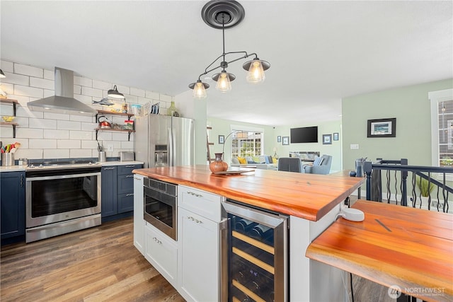 214 S Bradley St, Chelan, WA 98816 - kitchen with beverage cooler, appliances with stainless steel finishes, wall chimney range hood, butcher block countertops, and tasteful backsplash