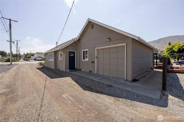 214 S Bradley St, Chelan, WA 98816 - view of front facade featuring a garage and driveway