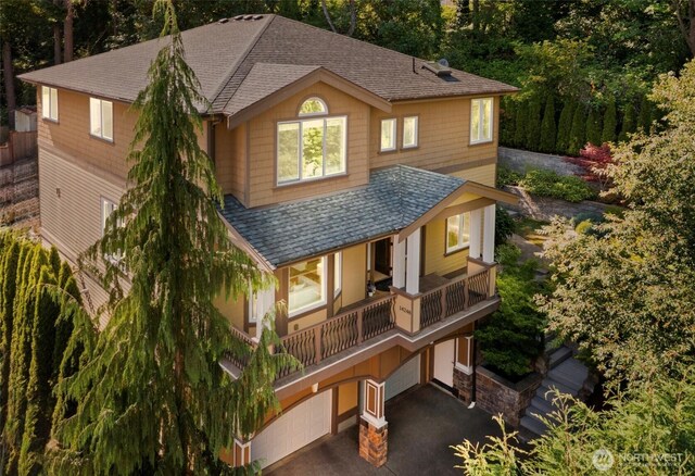 14248 SE Allen Rd, Bellevue, WA 98006 - view of front of property with a balcony, an attached garage, driveway, and a shingled roof