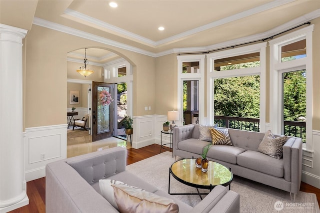 14248 SE Allen Rd, Bellevue, WA 98006 - living room with arched walkways, a decorative wall, dark wood-style flooring, a wainscoted wall, and ornamental molding