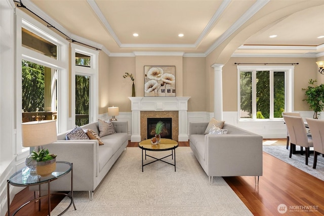 14248 SE Allen Rd, Bellevue, WA 98006 - living room with a raised ceiling, ornamental molding, light wood-type flooring, a fireplace, and wainscoting