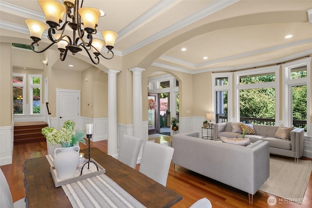 14248 SE Allen Rd, Bellevue, WA 98006 - dining space with arched walkways, healthy amount of natural light, a decorative wall, ornamental molding, and a chandelier