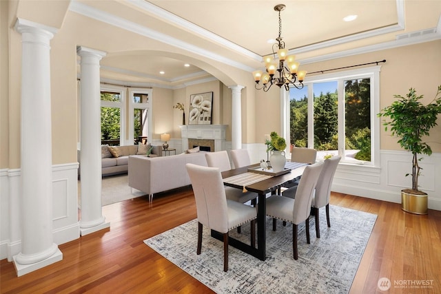 14248 SE Allen Rd, Bellevue, WA 98006 - dining space with a tray ceiling, healthy amount of natural light, light wood-style floors, a wainscoted wall, and crown molding