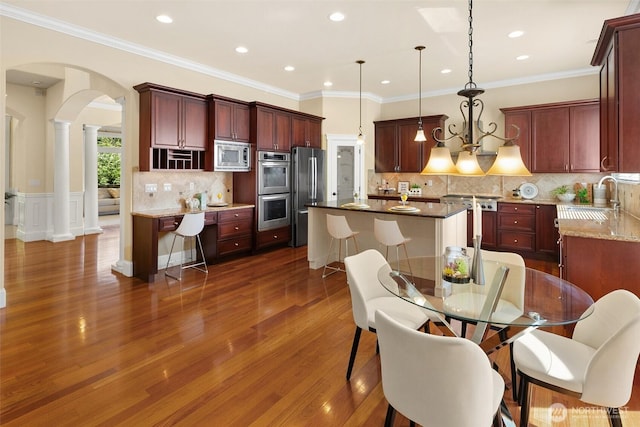 14248 SE Allen Rd, Bellevue, WA 98006 - dining room with decorative columns, arched walkways, dark wood-style floors, recessed lighting, and ornamental molding