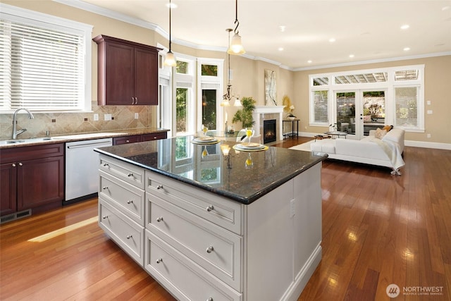 14248 SE Allen Rd, Bellevue, WA 98006 - kitchen featuring stainless steel dishwasher, open floor plan, plenty of natural light, light wood-style floors, and crown molding