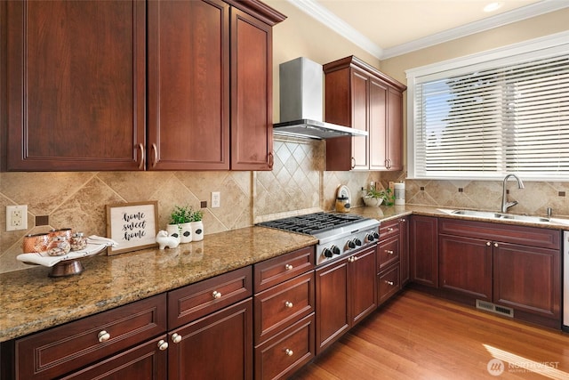 14248 SE Allen Rd, Bellevue, WA 98006 - kitchen featuring wall chimney exhaust hood, stainless steel gas stovetop, light stone countertops, light wood-style floors, and crown molding
