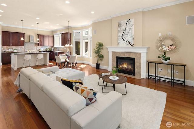 14248 SE Allen Rd, Bellevue, WA 98006 - living area featuring recessed lighting, dark wood-style flooring, ornamental molding, and a tiled fireplace