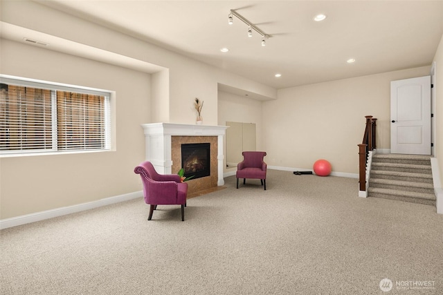 14248 SE Allen Rd, Bellevue, WA 98006 - sitting room with carpet, a tile fireplace, recessed lighting, rail lighting, and stairs