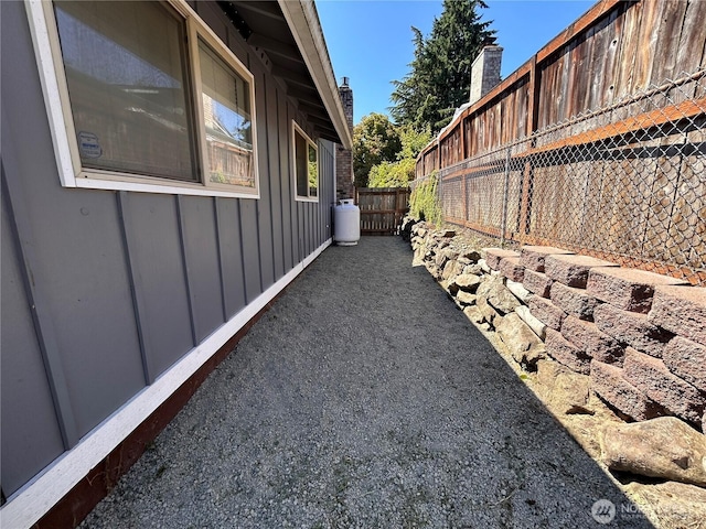 1221 E 63rd St, Tacoma, WA 98404 - view of home's exterior featuring board and batten siding and a fenced backyard