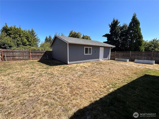 1221 E 63rd St, Tacoma, WA 98404 - back of house featuring a fenced backyard and an outdoor structure