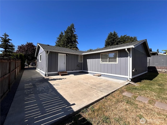 1221 E 63rd St, Tacoma, WA 98404 - back of house featuring board and batten siding, a patio area, and entry steps