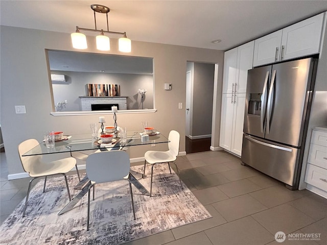 1221 E 63rd St, Tacoma, WA 98404 - dining room featuring dark tile patterned floors, a wall mounted AC, and a brick fireplace
