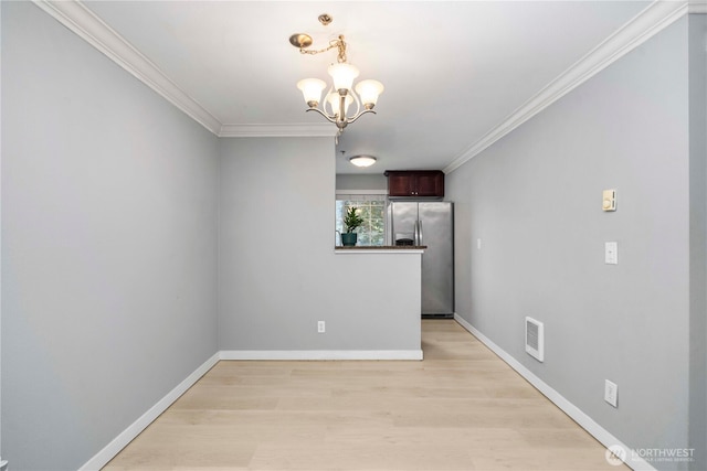1839 S 286th Ln Unit S-201, Federal Way, WA 98003 - spare room featuring a chandelier, crown molding, and light wood-style floors