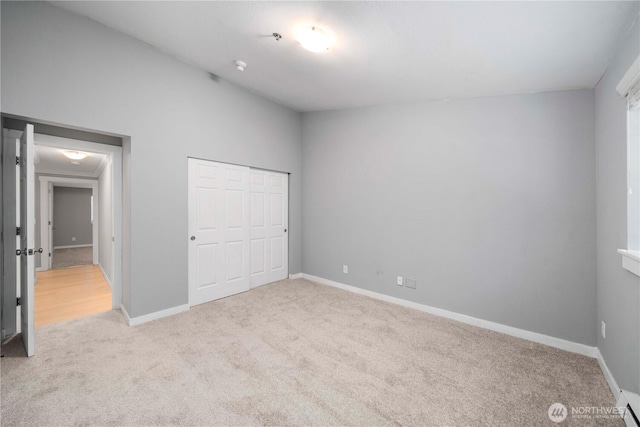 1839 S 286th Ln Unit S-201, Federal Way, WA 98003 - unfurnished bedroom featuring light colored carpet, a baseboard radiator, and a closet